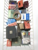 A metal tray of assorted stationary and office equipment