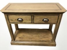 A contemporary stained oak two drawer side table, 98 cm x 45 cm x 80 cm.