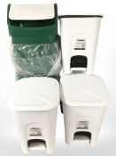 A group of plastic pedal bins.