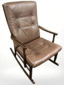A Scandinavian beech and brown stitched leather rocking chair