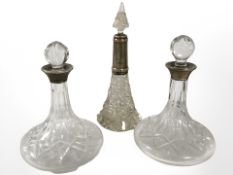 A pair of silver collared crystal dressing table bottles in the form of ships decanters, height 15.