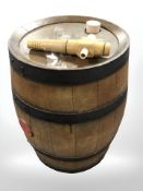 A coopered oak barrel with tap, height 35 cm.