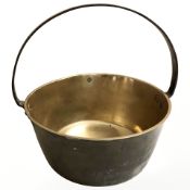 A Victorian brass jam pan with cast iron handle, diameter 34 cm.