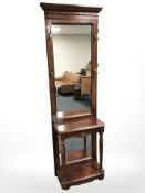 A reproduction mirrored hall stand, width brass coat hooks,