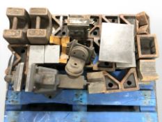 A large cast iron bench vice, two 56 pound cast iron weights, smaller vice and similar items.