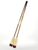 A pair of reproduction painted wooden oars,