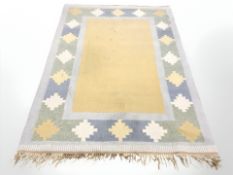 A flat weave geometric rug, 205 cm x 139 cm.