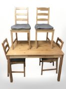 A contemporary pine kitchen table, length 118 cm, and a set of four ladder back chairs.