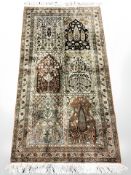 A Ghom silk-piled rug, Central Iran, 152 cm x 77 cm.