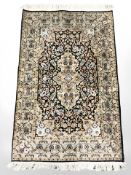 A Ghom silk-piled rug, Central Iran, 131 cm x 79 cm.