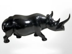 A carved and ebonised hardwood rhinoceros,