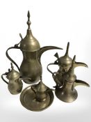 A graduated set of five Turkish brass coffee pots and a further dish, tallest 27.5 cm.