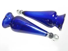 A pair of two tone clear and blue glass conical hanging vessels, length 37 cm.