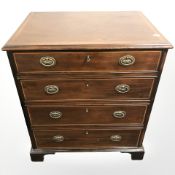 An Edwardian mahogany single door storage cabinet with dummy drawers to front,