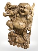 A contemporary Eastern hardwood carving of Buddha, height 61 cm.