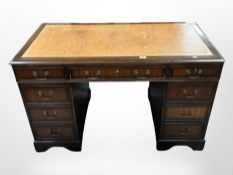 A reproduction mahogany twin-pedestal writing desk,