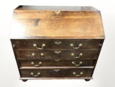 A George III oak bureau, 99 cm x 52 cm x 95 cm.