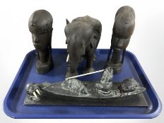 A pair of African carved hardwood busts, similar figure of an elephant and a Canadian Inuit carving.