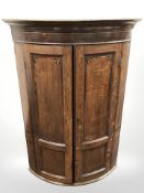 A George III inlaid oak bow-front china cabinet,