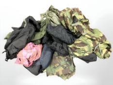 A quantity of outdoor clothing including overalls, gilets, etc.