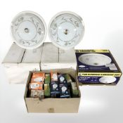 A group of boxed light fittings, bulbs.