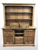 An Ercol elm dresser, 145 cm x 53 cm x 190 cm.