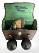A leather bowls case containing two Taylor Rolph Co. bowls, pair of bowling shoes.