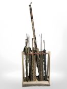 A rustic pine fishing rod stand containing 6 split cane rods in canvas slips including J. A.