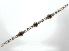A 9ct yellow gold bracelet set with garnets, length 18 cm. CONDITION REPORT: 4.5g.