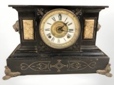 A Victorian black slate eight day mantel clock with enameled dial, height 26 cm.
