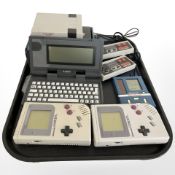 Two Nintendo Gameboys, an Atari portfolio, grand stand game, a mini games classic games collection,