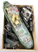 A remote controlled model fishing trawler and several hand sets.