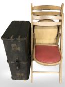 A pair of folding chairs and a luggage case