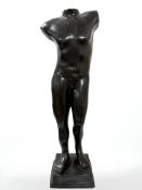 A cast and patinated bronze statue of a nude male,