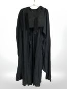 A graduation robe and mortar board hat.