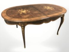 An Italian style high gloss dining table with gilt metal mounts,