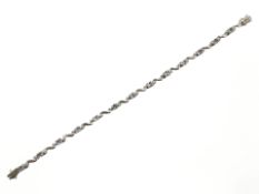 A 9ct white gold bracelet set with diamond chips and semi previous stones, length 18 cm.