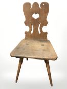 A 19th century rustic oak chair with carved heart back rest,
