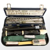 A Boosey & Hawkes emperor three piece chrome flute in box, an Aulos recorder and several harmonicas.