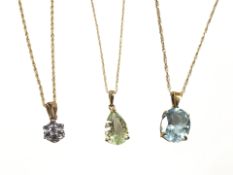 Three 9ct yellow gold necklaces each set with semi precious stone pendants.