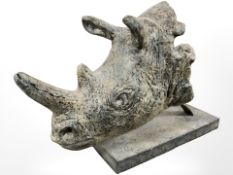 A contemporary composition rhinoceros head on plinth, length 61 cm.