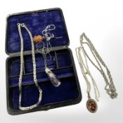 A group of jewellery to include white metal rope twist chain, amber floral brooch etc.