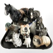 A group of china shire horse figures and other animal ornaments.