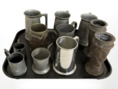 A group of pewter tankards, a further wooden tankard carved with a dragon, pair of hammered vases,