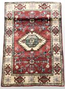An Afghan rug of caucasian design, 125 cm x 84 cm.