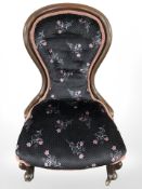 A late Victorian mahogany lady's chair in contemporary floral upholstery.