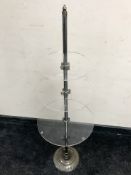 A chrome and perspex three tier stand, height 108 cm.