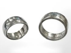 Two silver rings formed from a USA half dollar and Newfoundland coin.