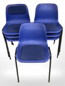 Seven stacking plastic chairs