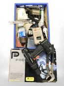 A boxed Pro 1400W circular saw and a crate containing electric hand drill, vintage blow lamp,